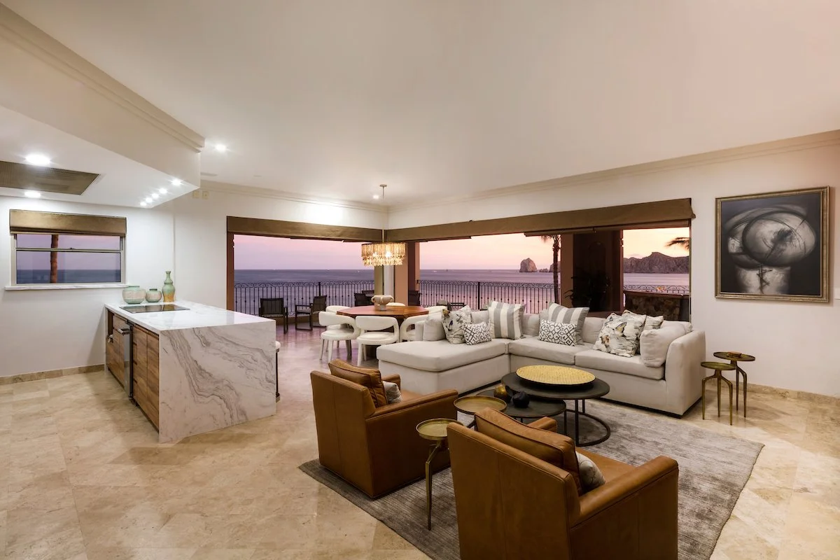 Living room of Villa La Estancia 3301 with floor-to-ceiling sliding glass doors and ocean view