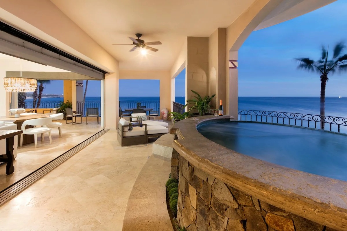 Villa La Estancia 3301 terrace at twilight with the jacuzzi lit and the bay beyond